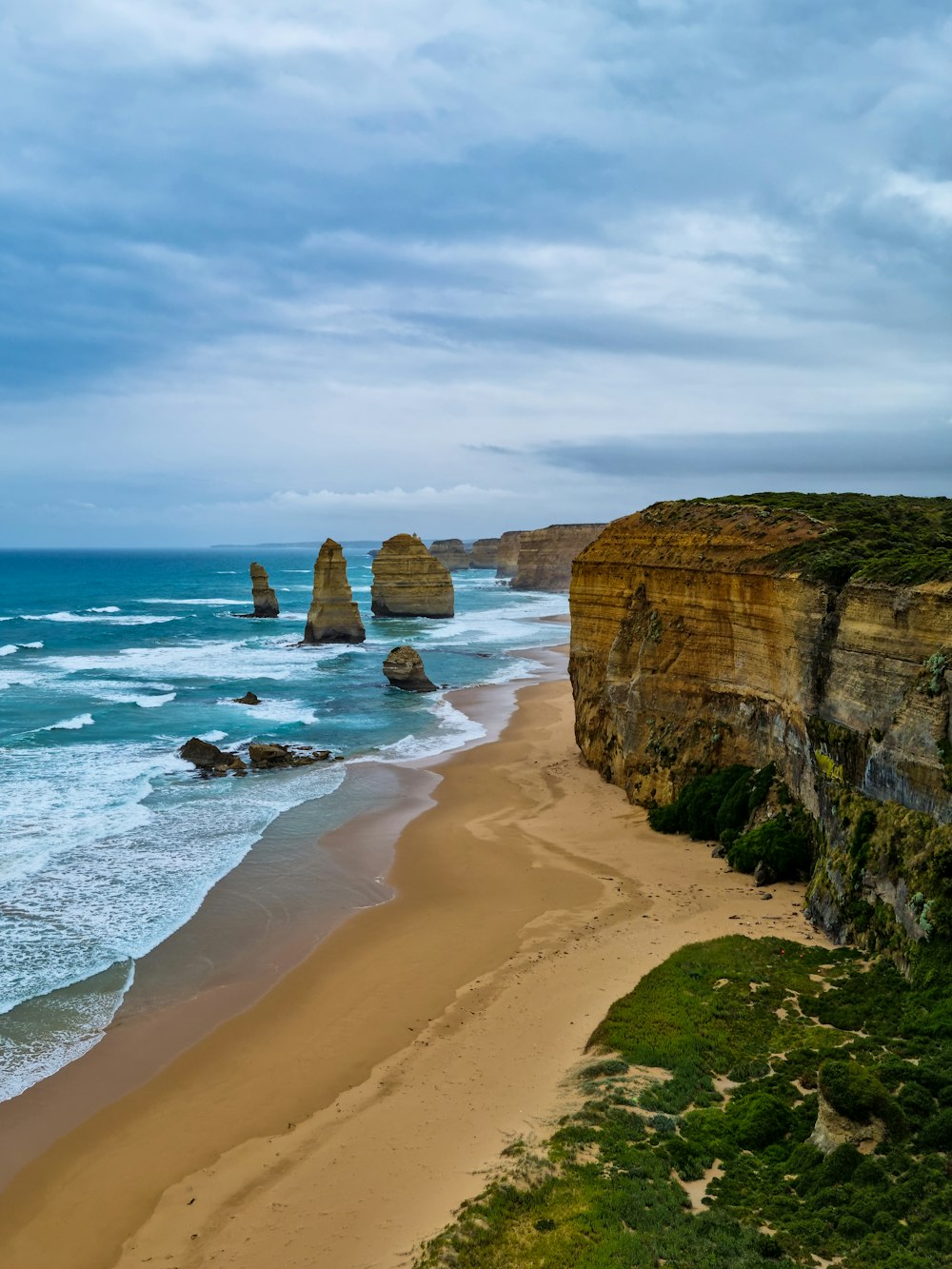 a view of a beach with a cliff in the background