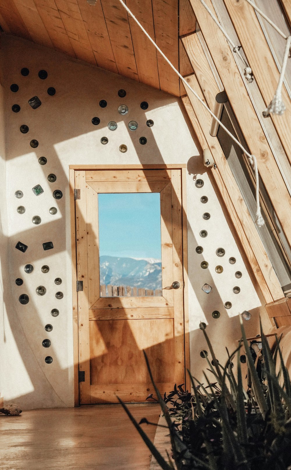 a wooden door sitting inside of a room next to a window