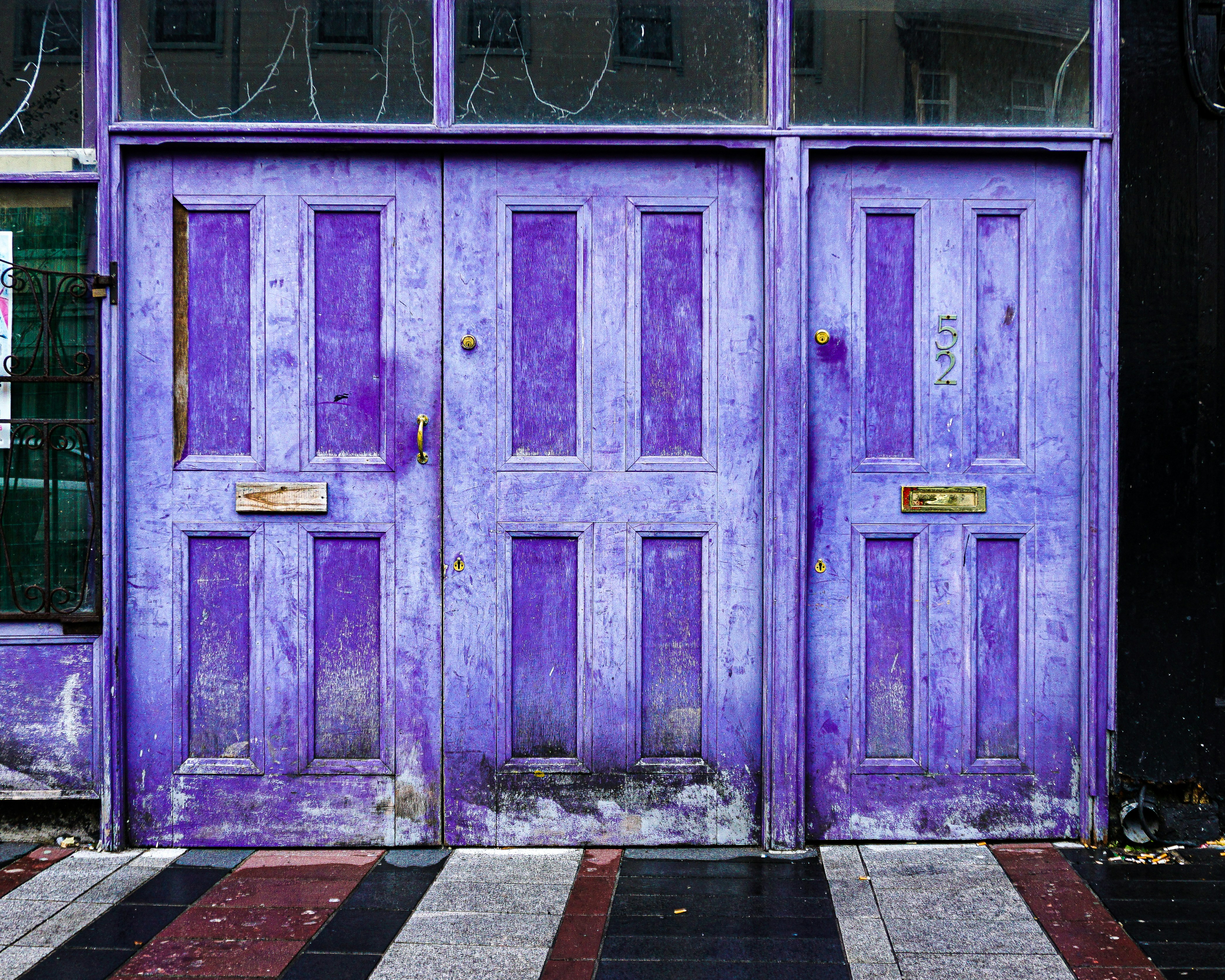 a purple door with a black and white checkered floor
