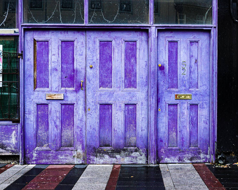 a purple door with a black and white checkered floor