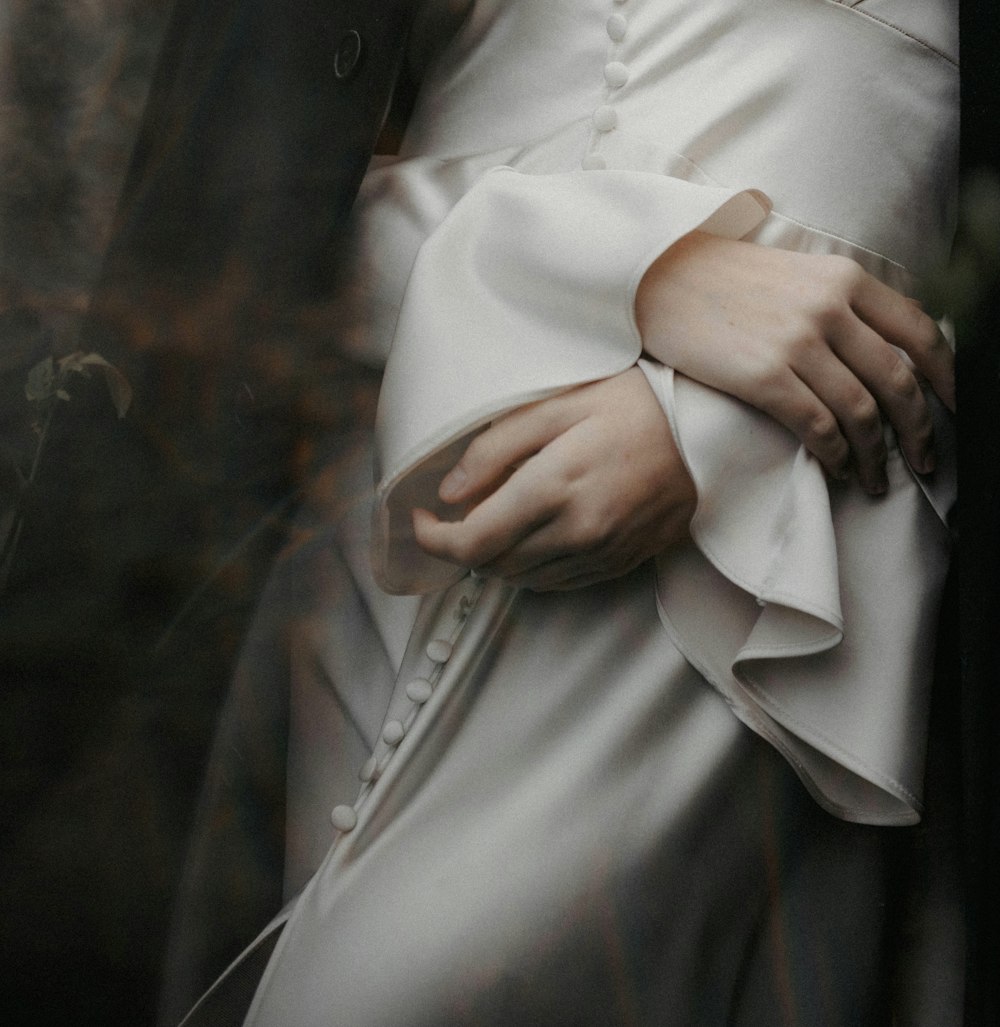 a close up of a person wearing a white dress
