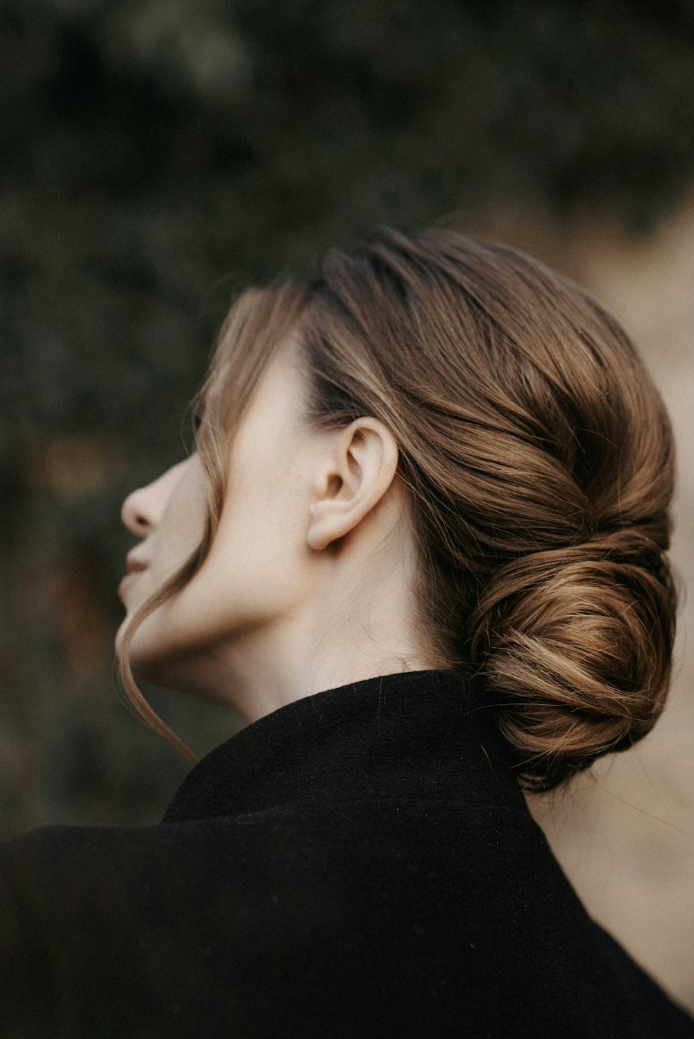 a woman with her hair in a low bun