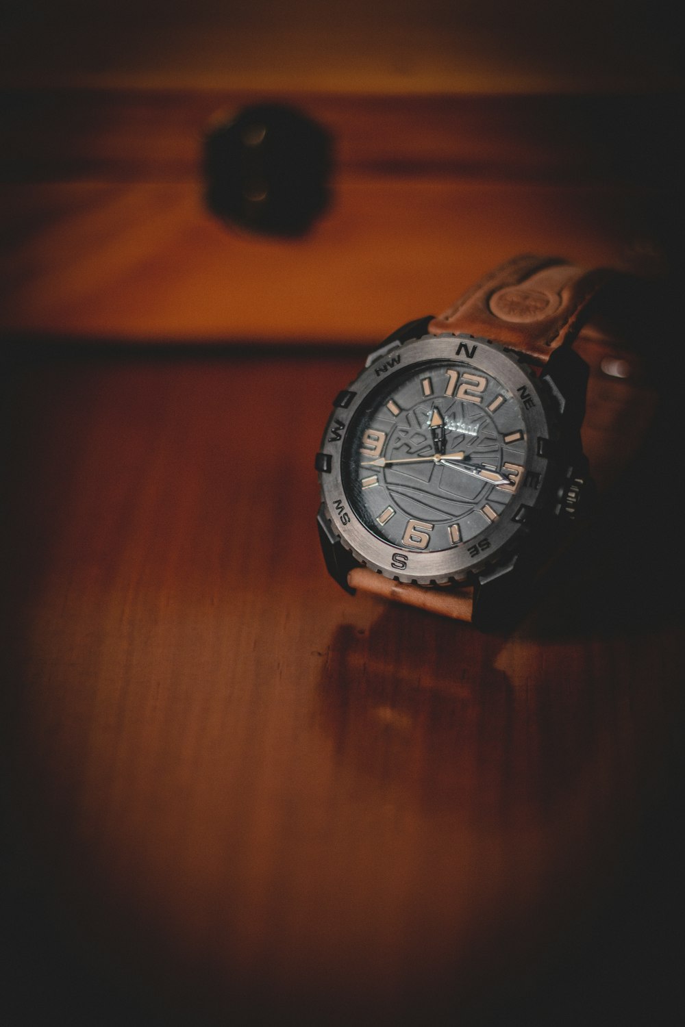 a watch sitting on top of a wooden table