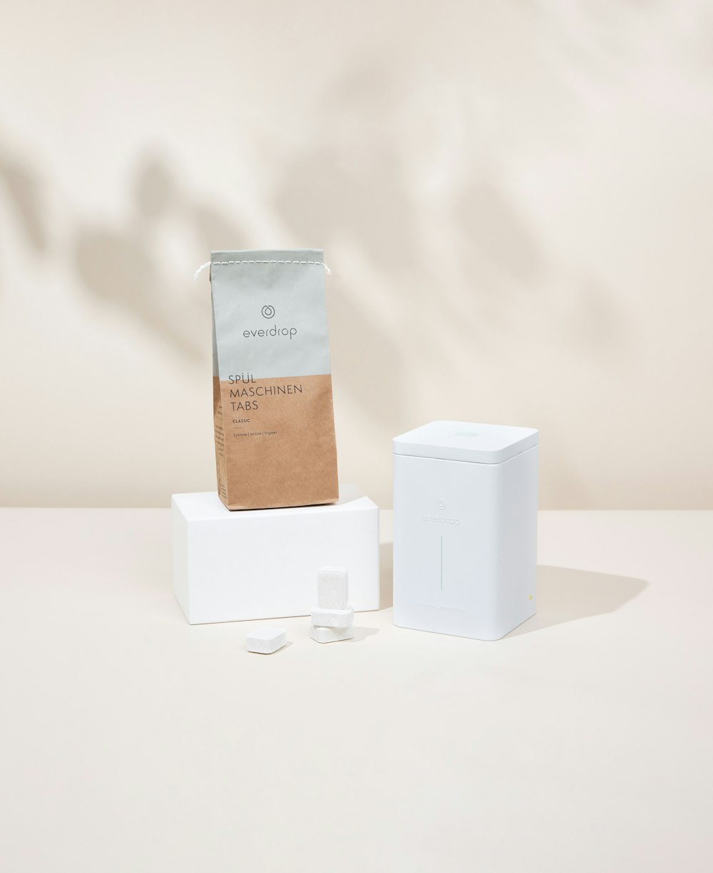 a bag of coffee sitting on top of a white box