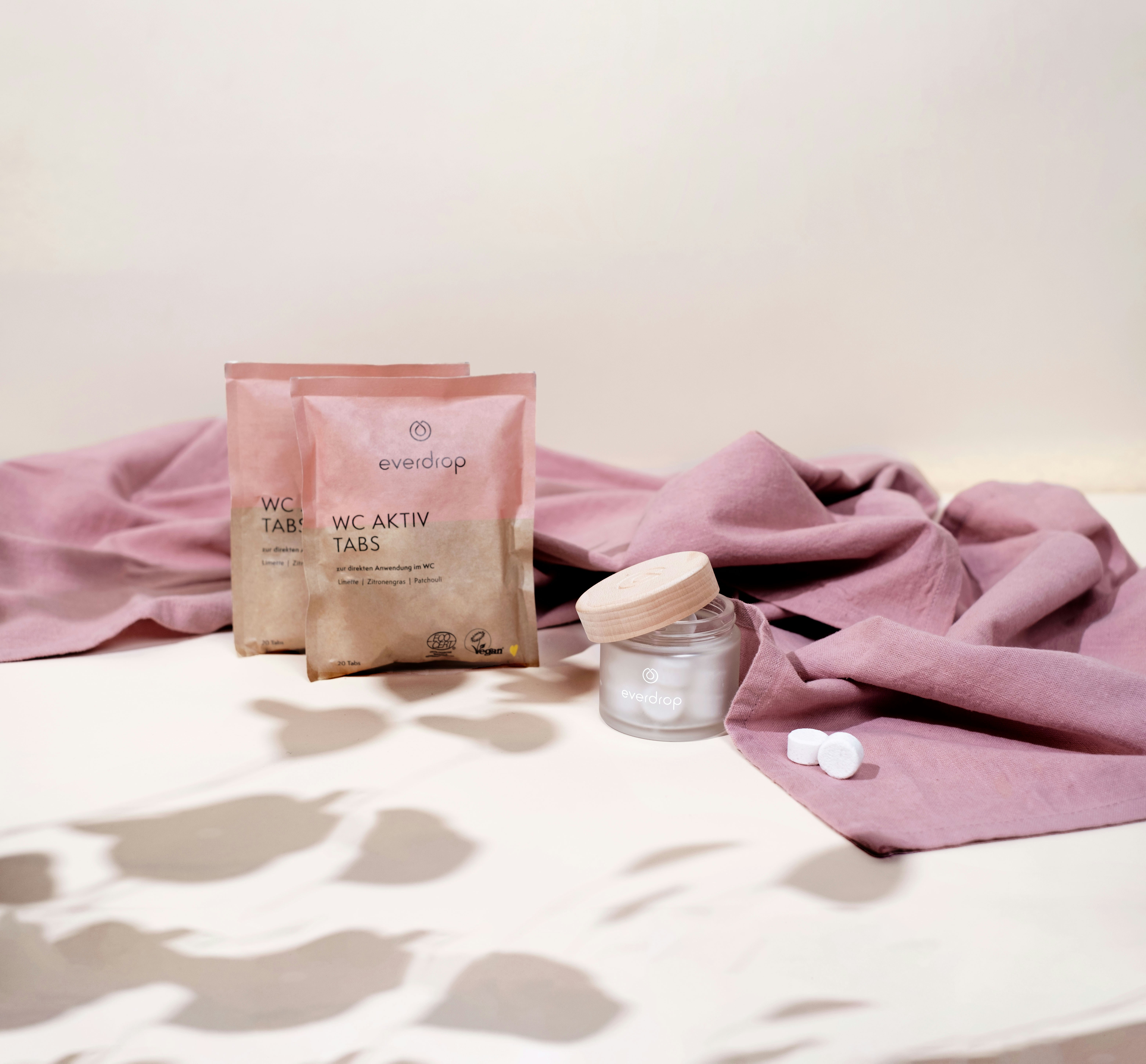 a bag of skin care products sitting on a bed