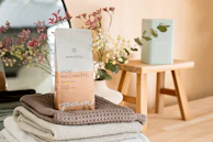 a stack of folded towels sitting on top of a wooden table