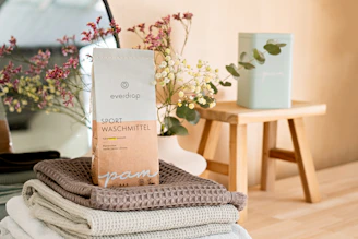 a stack of folded towels sitting on top of a wooden table