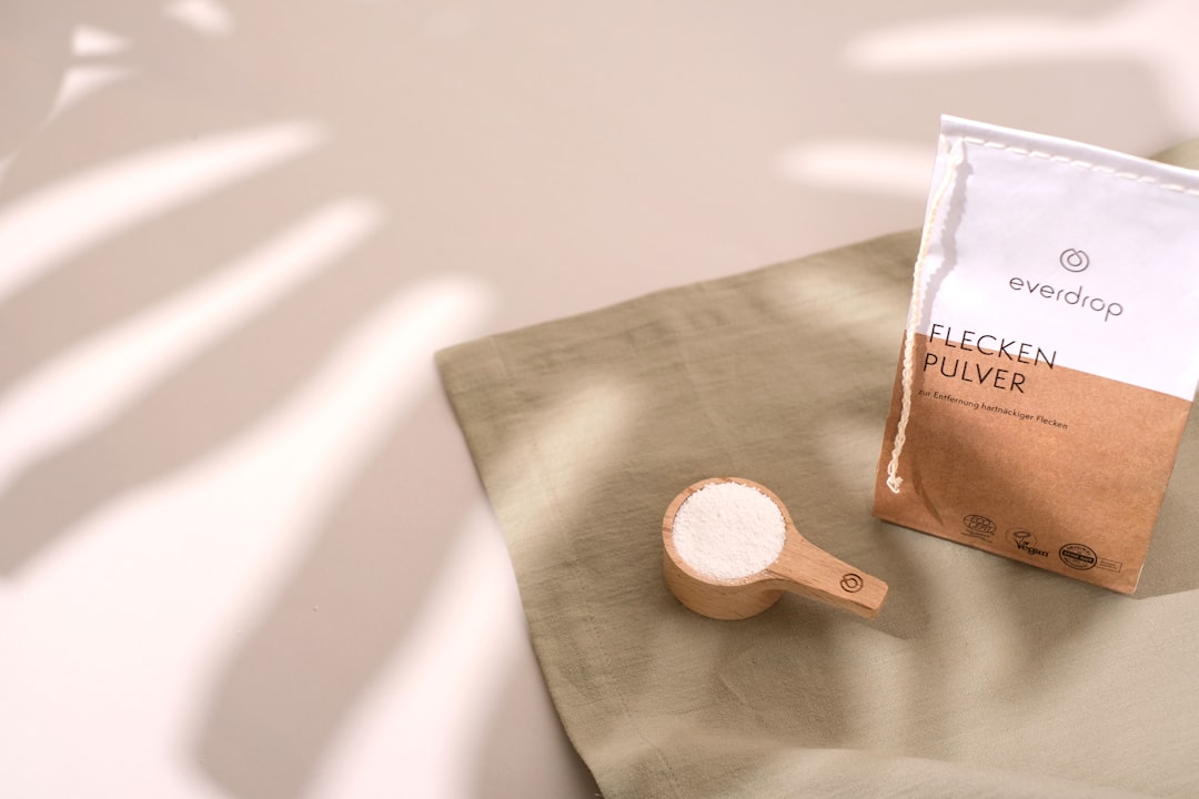 a bag of coffee next to a wooden spoon,