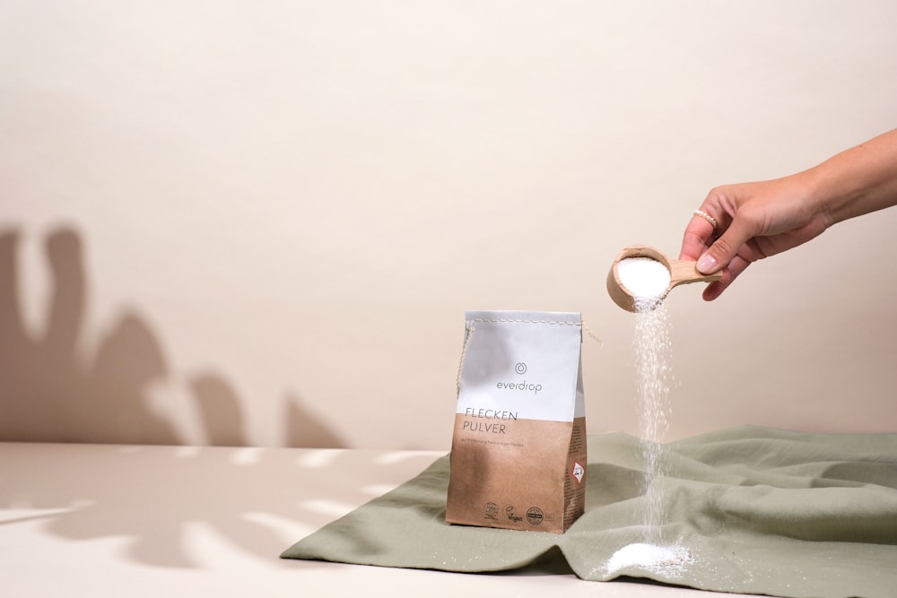 a bag of coffee being poured into a bag