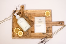 a bottle of lotion sitting on top of a cutting board