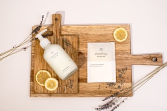 a bottle of lotion sitting on top of a cutting board