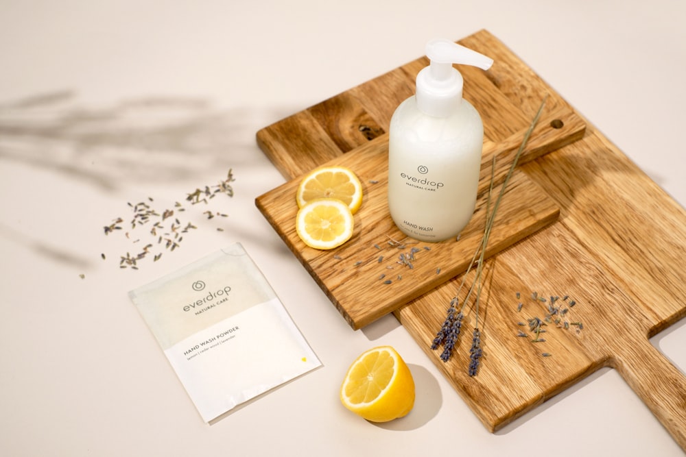 a bottle of lotion sitting on top of a cutting board