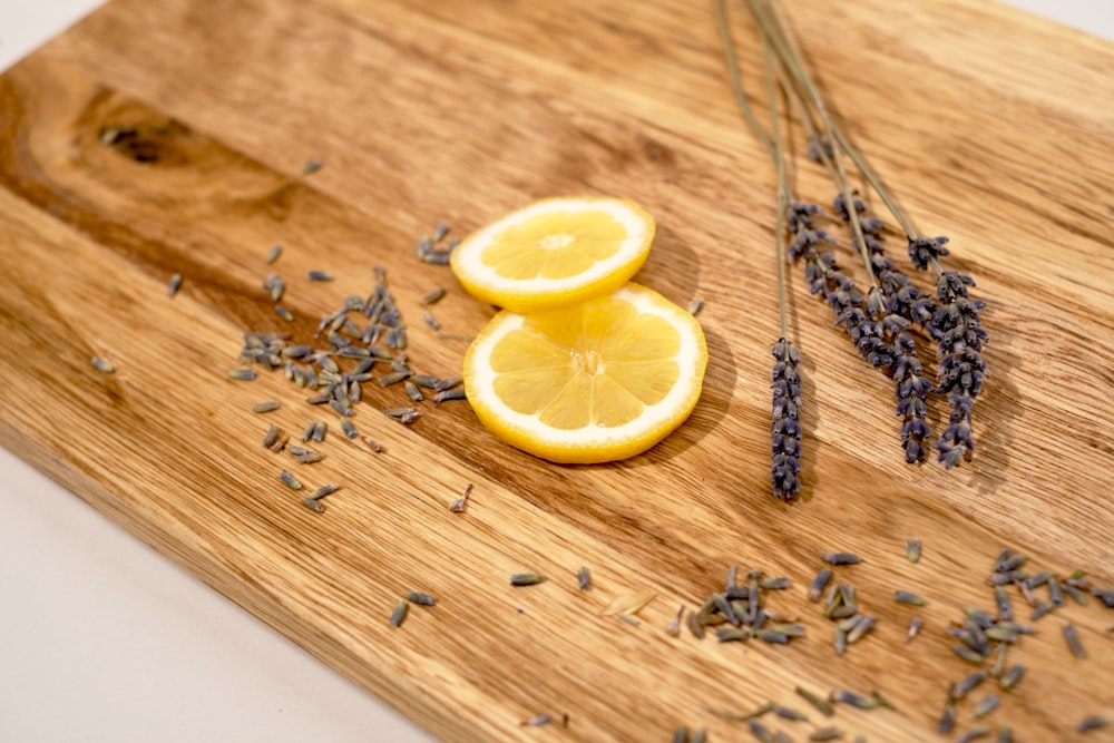 a cutting board topped with sliced lemons and lavender