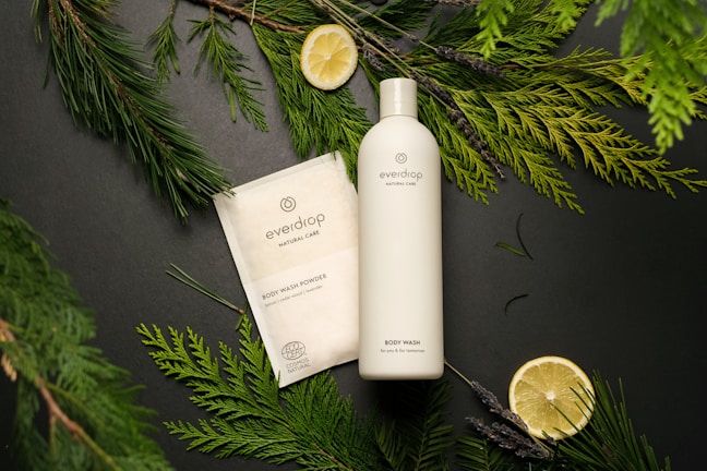 a bottle of body lotion next to a package of soap