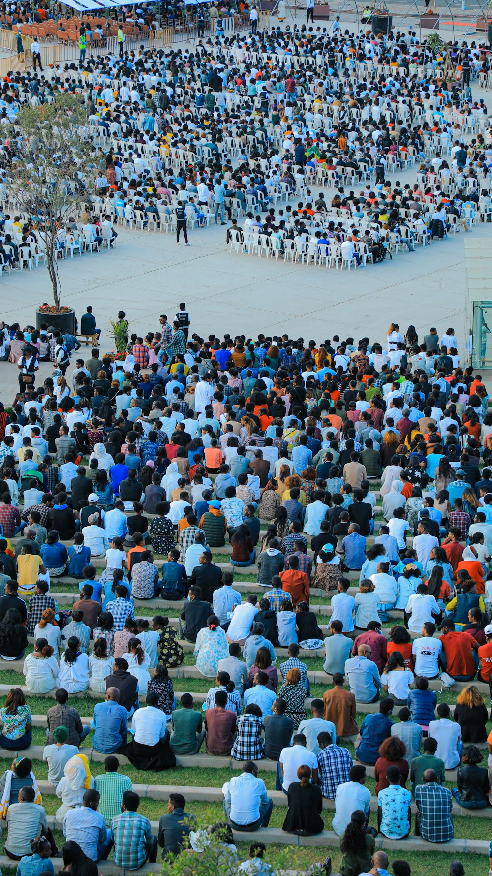 a group of people standing in front of a large crowd of people