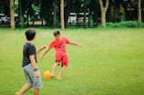 a couple of kids playing a game of soccer