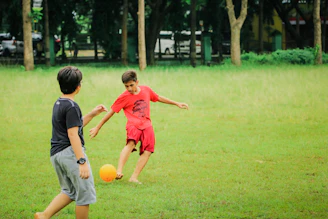 a couple of kids playing a game of soccer