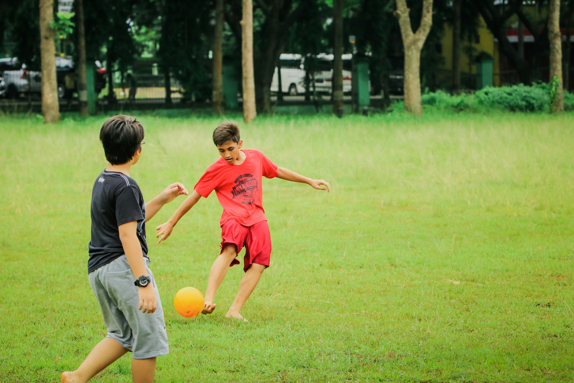 a couple of kids playing a game of soccer