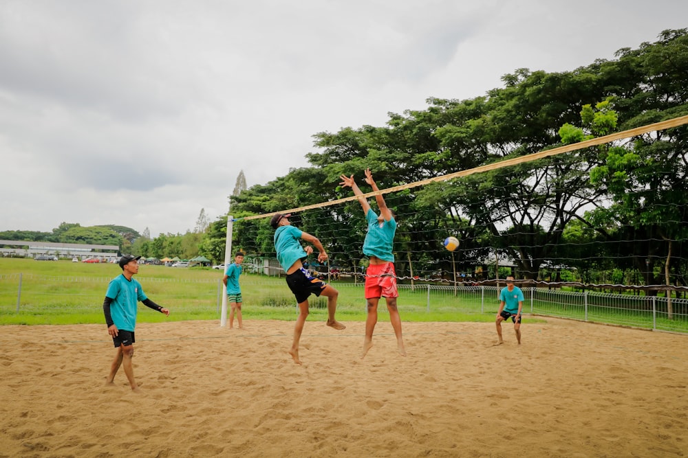 a group of young men playing a game of volleyball