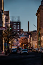 a city street filled with lots of traffic next to tall buildings