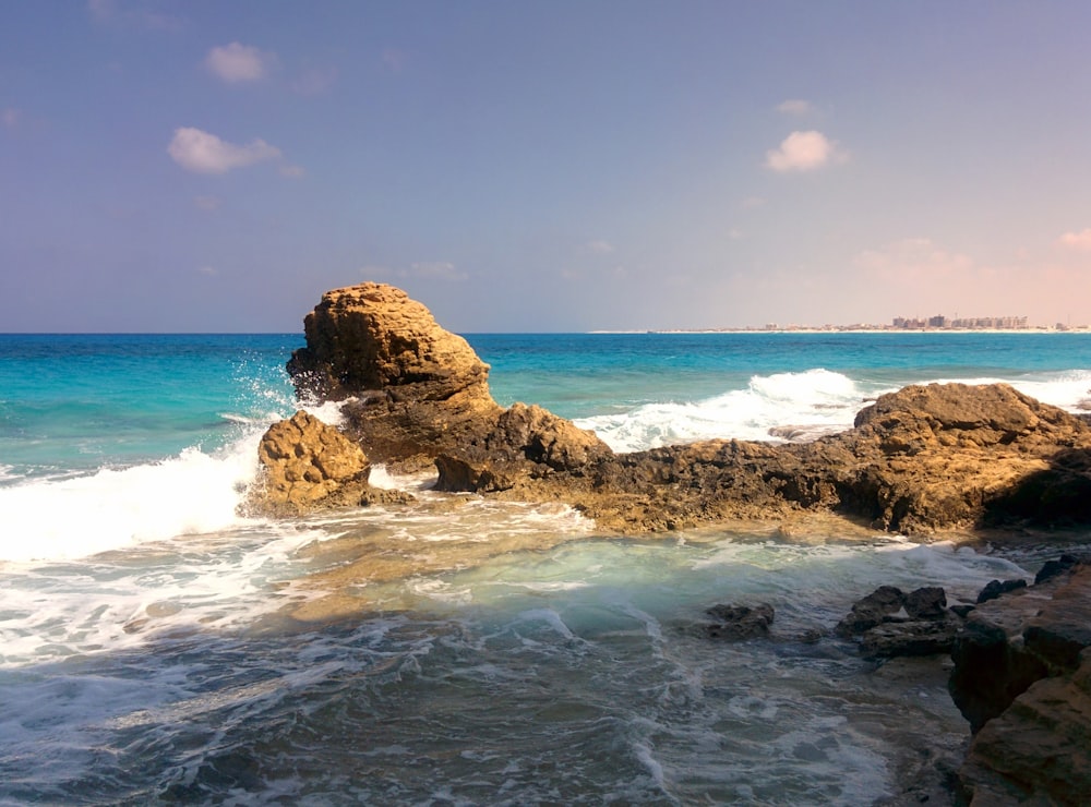 a large rock sticking out of the ocean