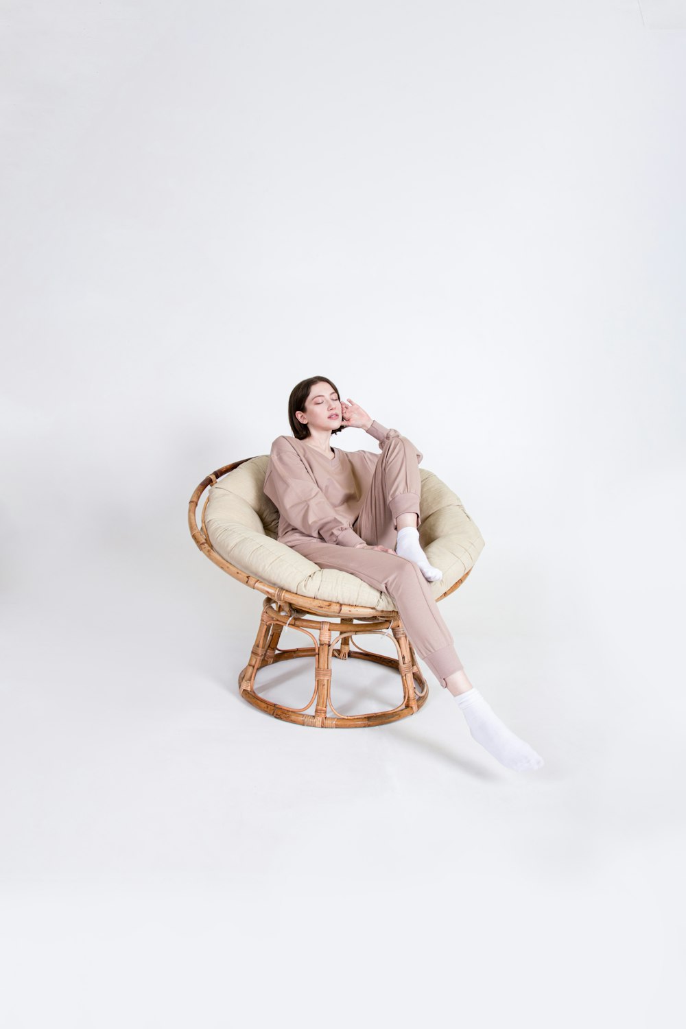 a woman sitting in a chair with her legs crossed