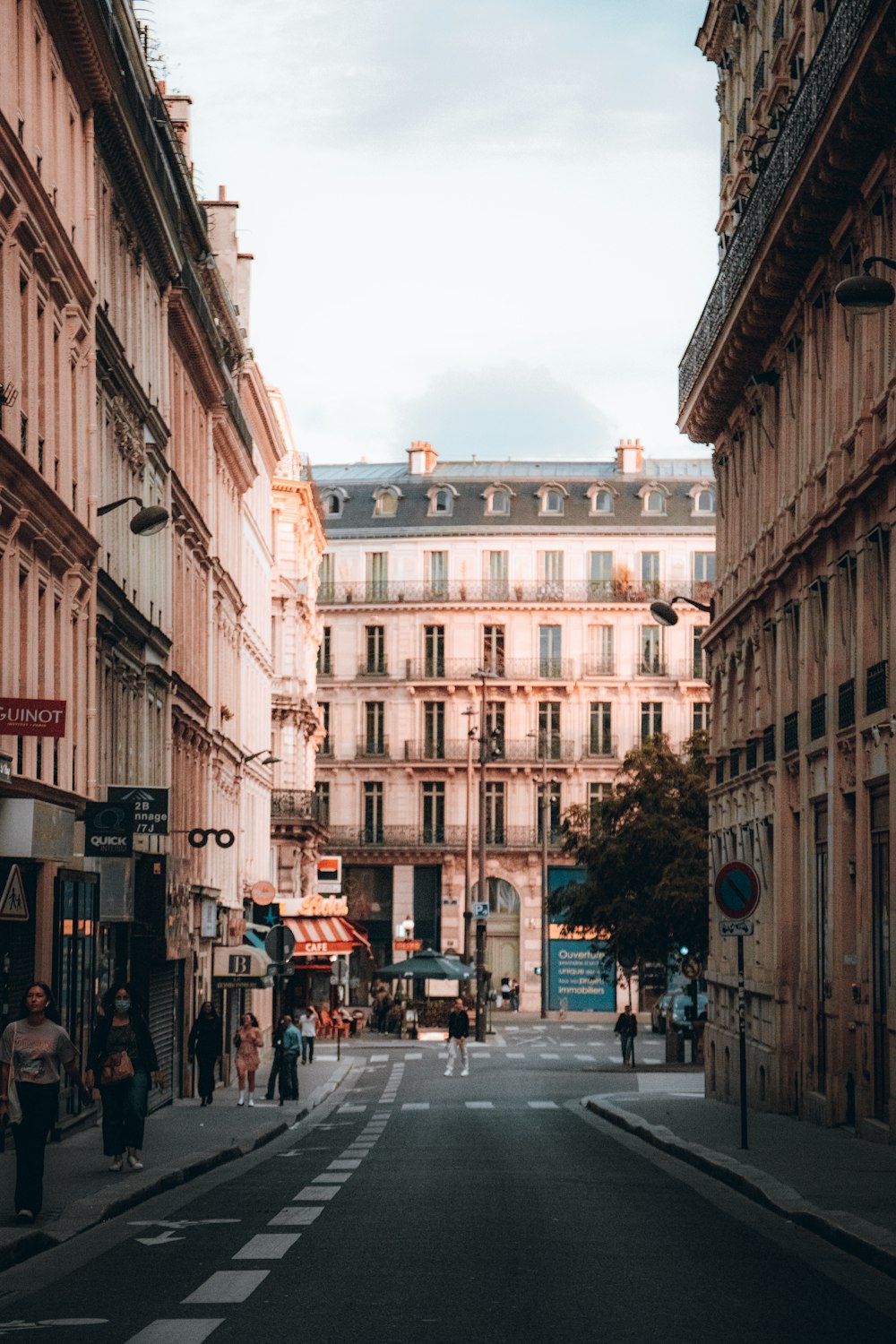 a narrow city street lined with tall buildings