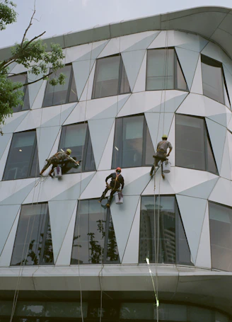a group of men climbing up the side of a building