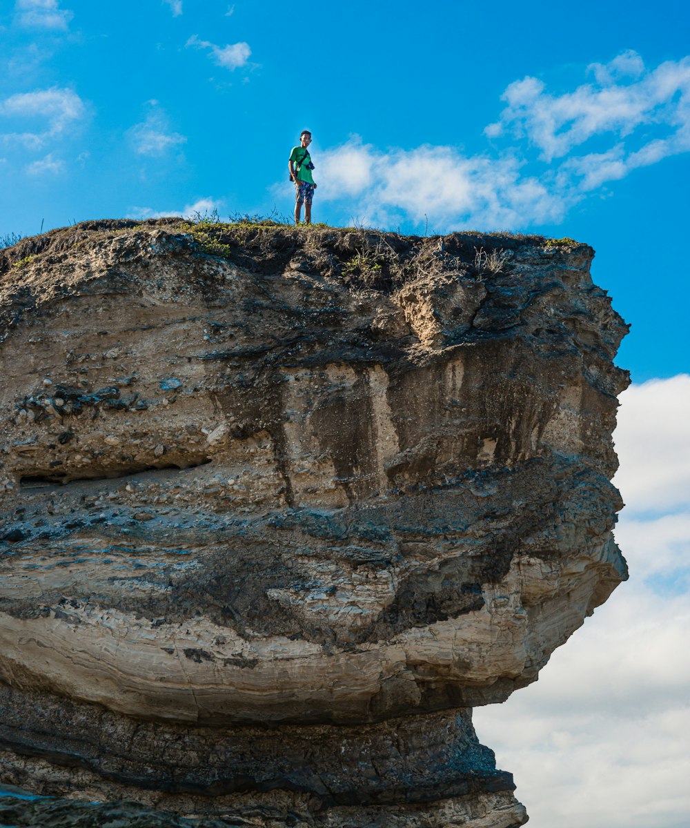 a person standing on top of a cliff