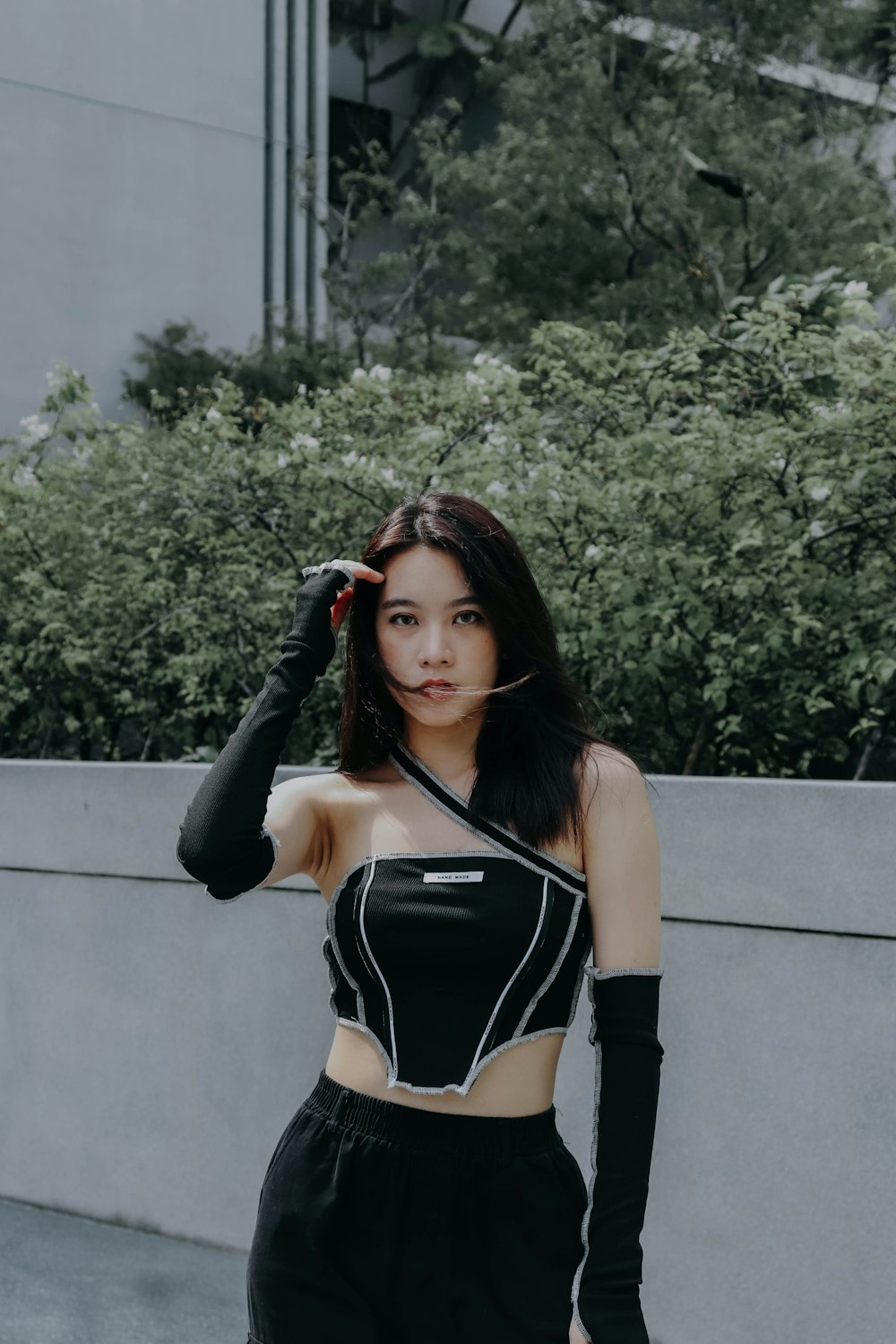 a woman in a crop top and black pants