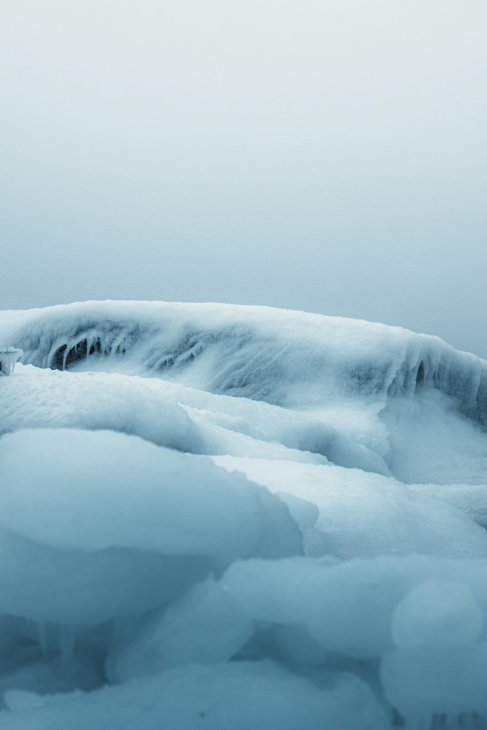 a large amount of ice floating on top of a body of water