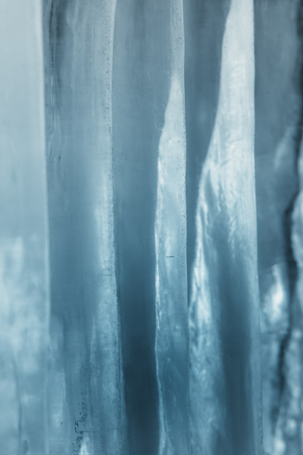 a person standing in front of a window covered in ice