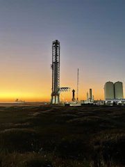 Satellite launch platform equipped with hydrogen propulsion modules at twilight.