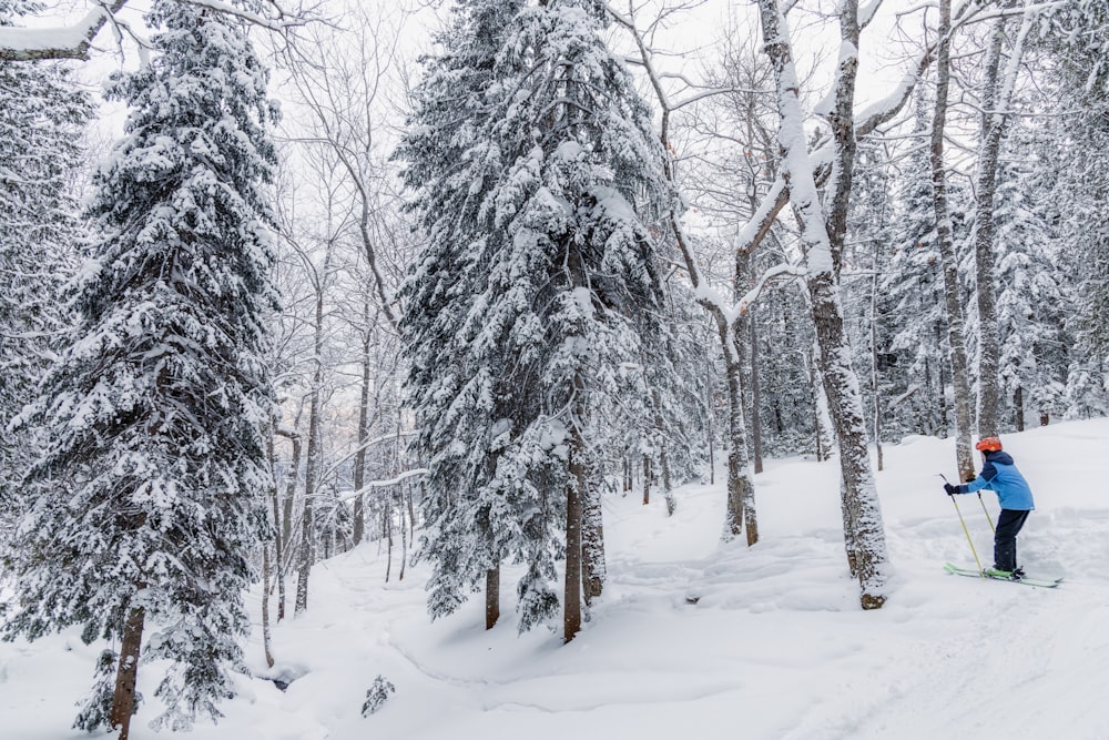 a man riding skis down a snow covered slope