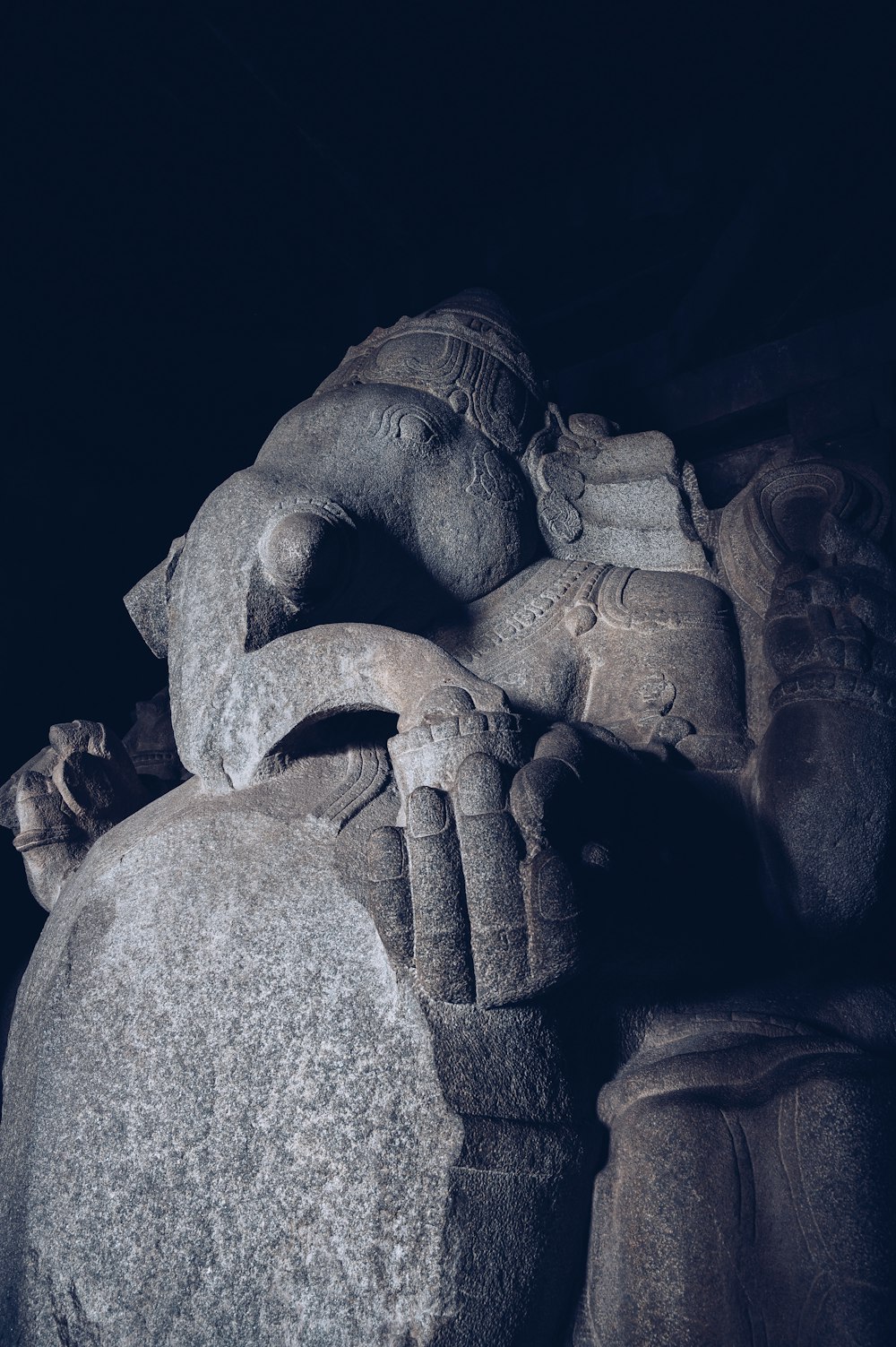 a close up of a statue with a dark background
