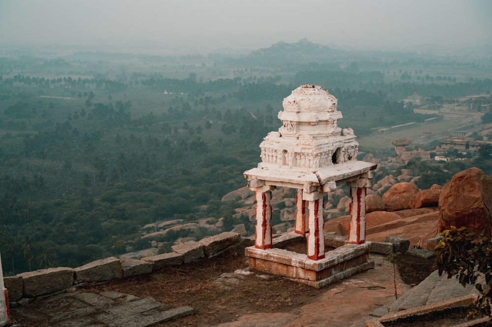 a small white structure on top of a mountain