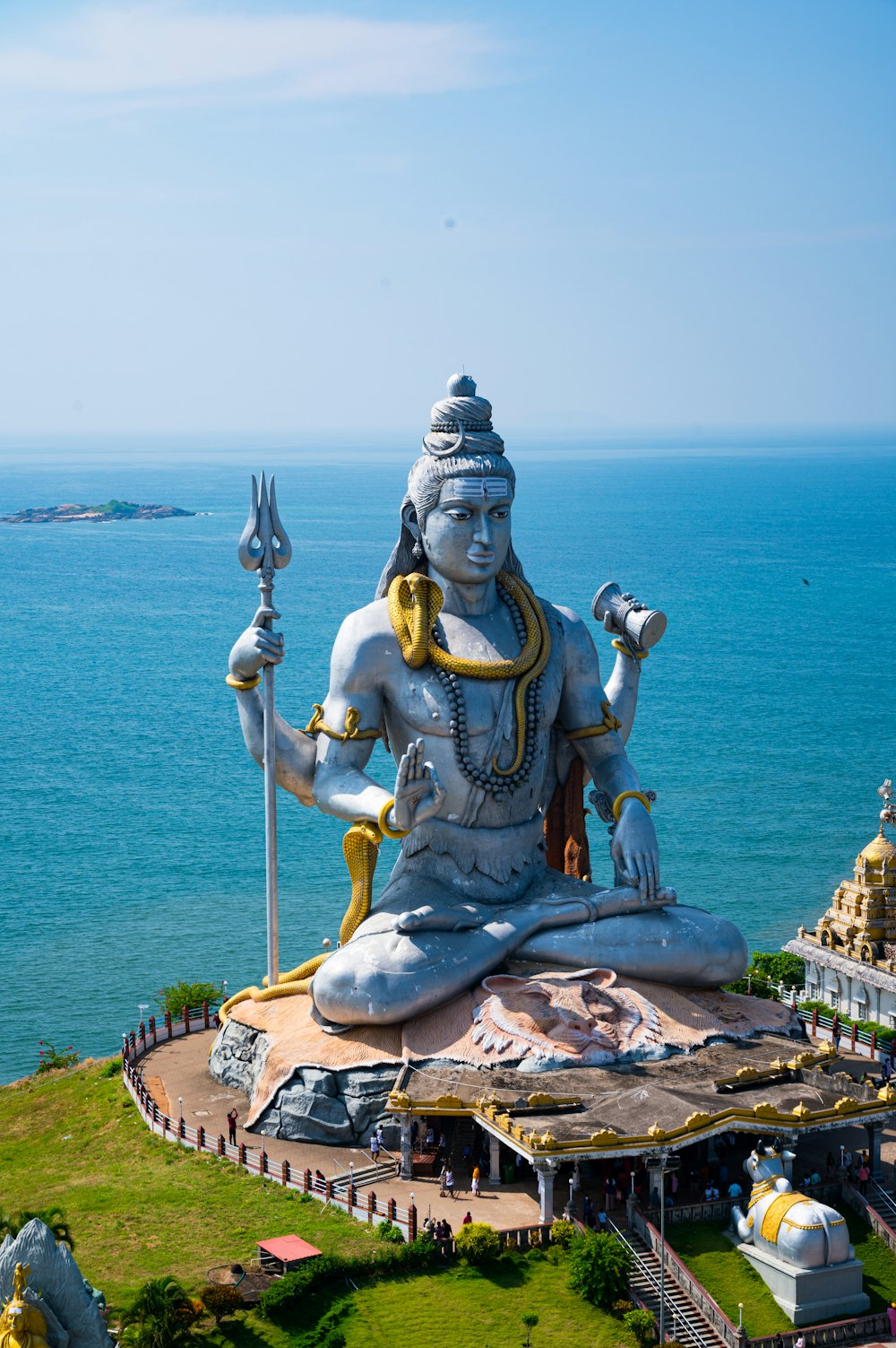 a statue of a person sitting on top of a hill