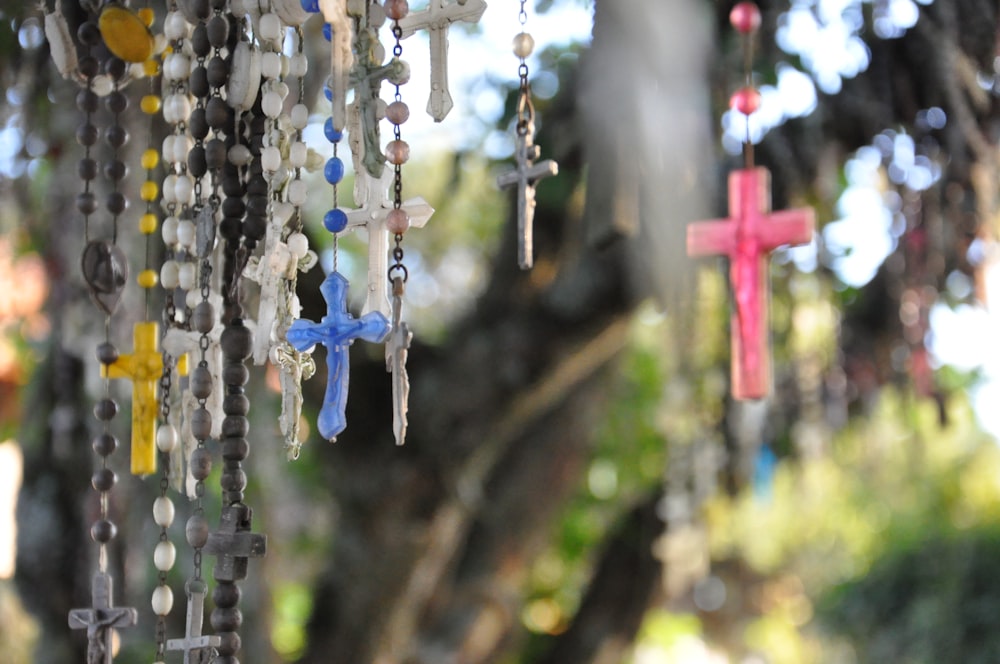 a group of crosses hanging from a tree