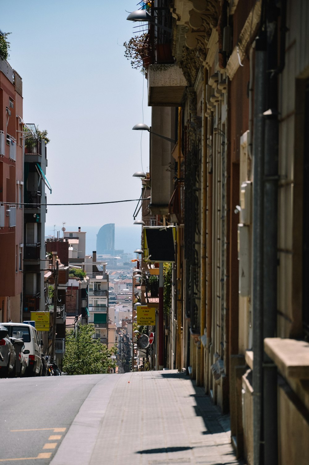 a city street lined with tall buildings and parked cars