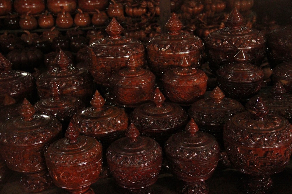 a lot of brown jars sitting next to each other