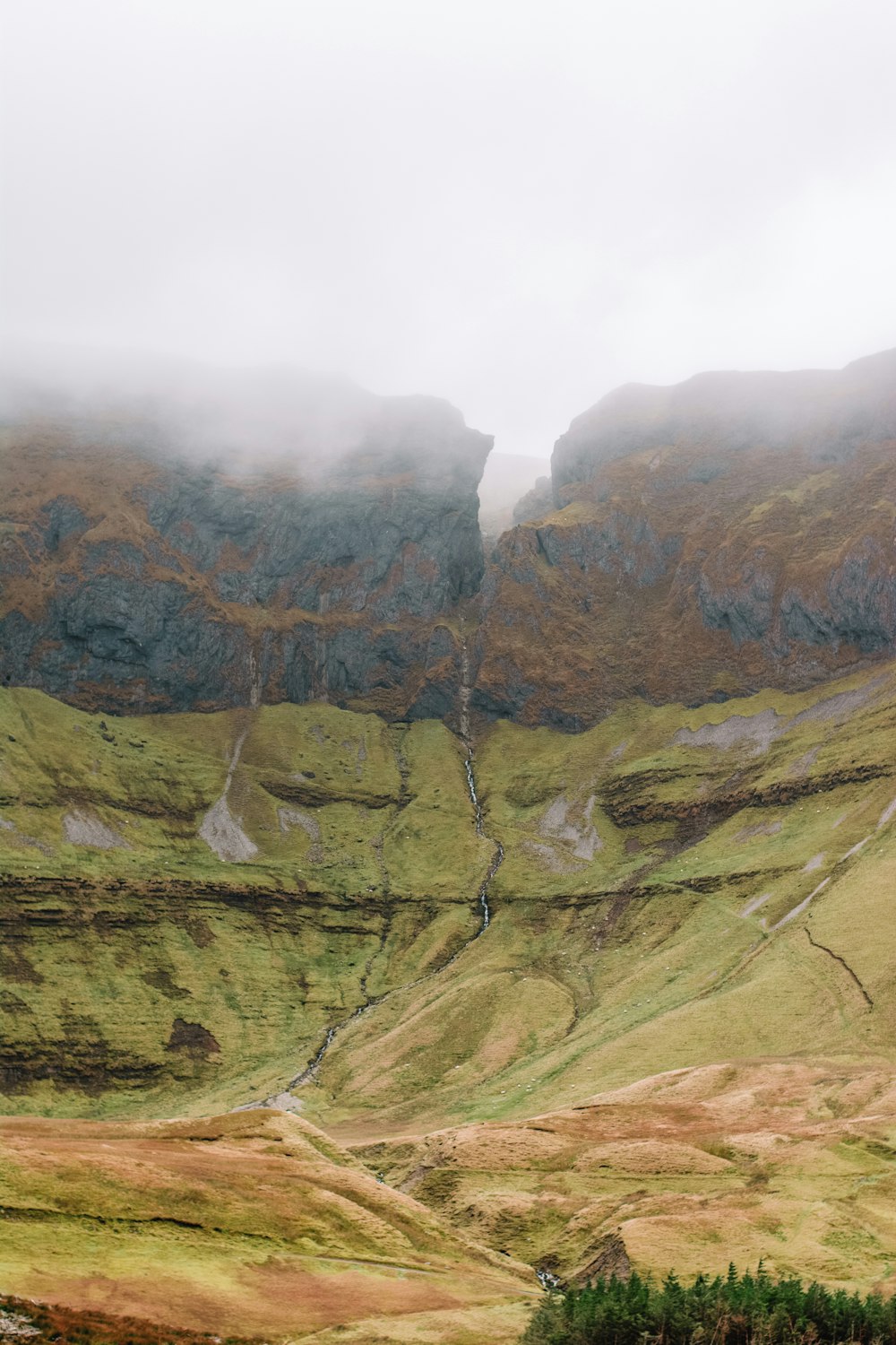 the mountains are covered in fog and clouds