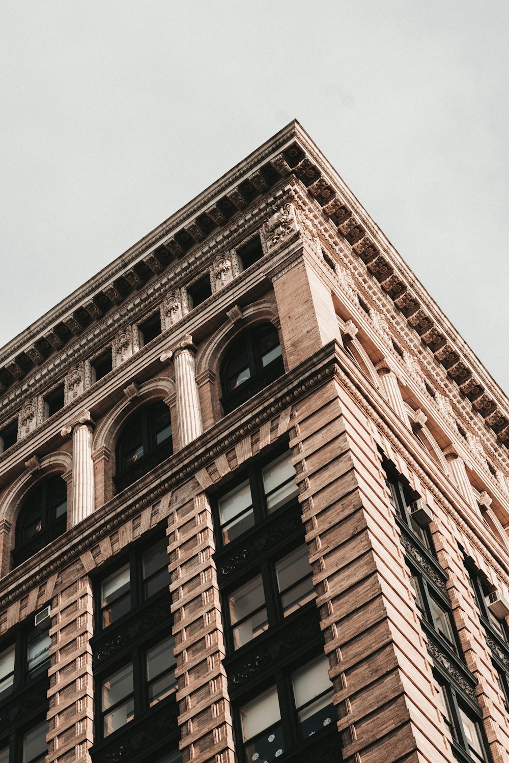 a tall brick building with a clock on the top of it