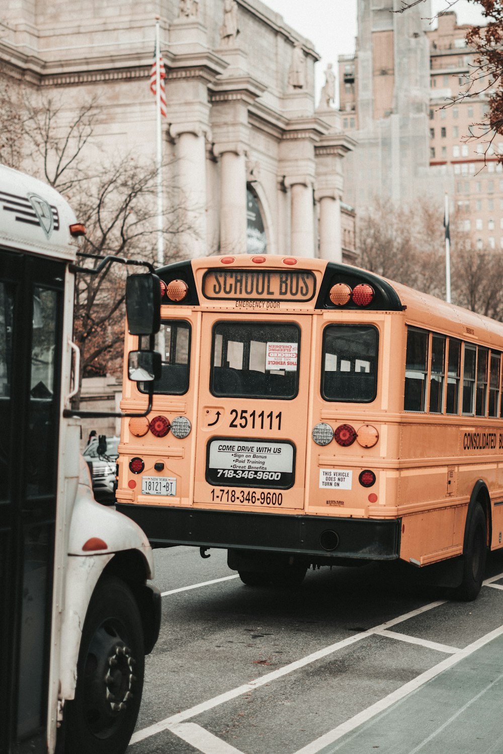 a yellow school bus driving down a street