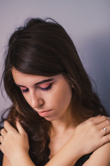 a woman is holding her arm around her neck