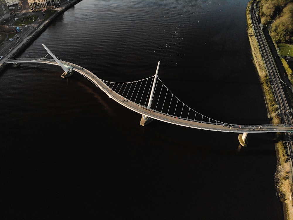 an aerial view of a bridge over a body of water