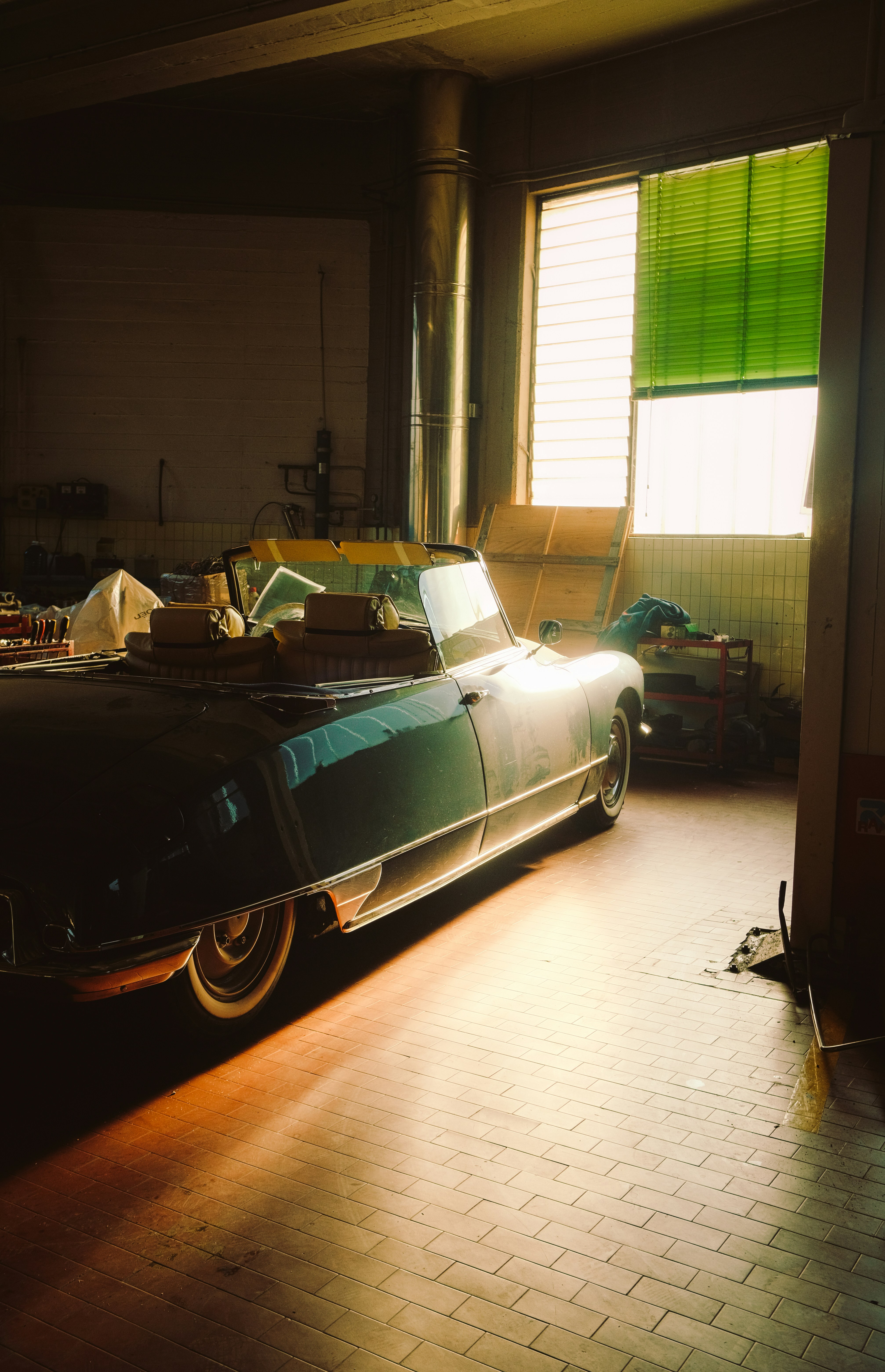 a black car parked in a garage next to a window