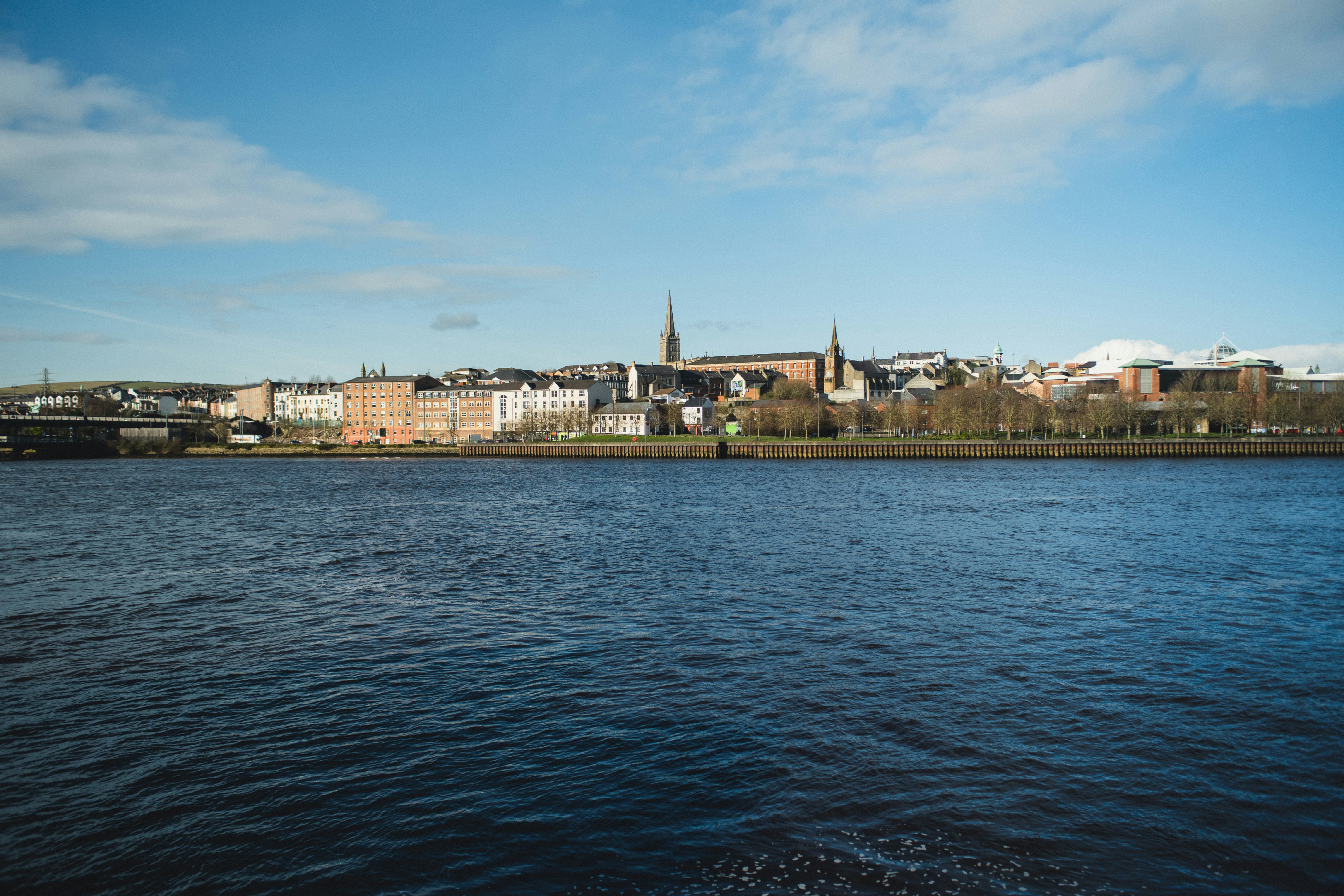a body of water with a city in the background