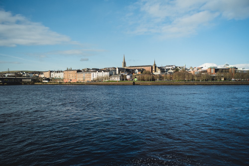 a body of water with a city in the background