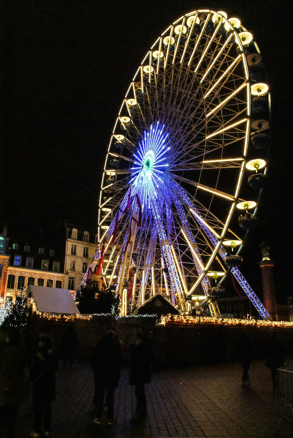 a large ferris wheel lit up at night