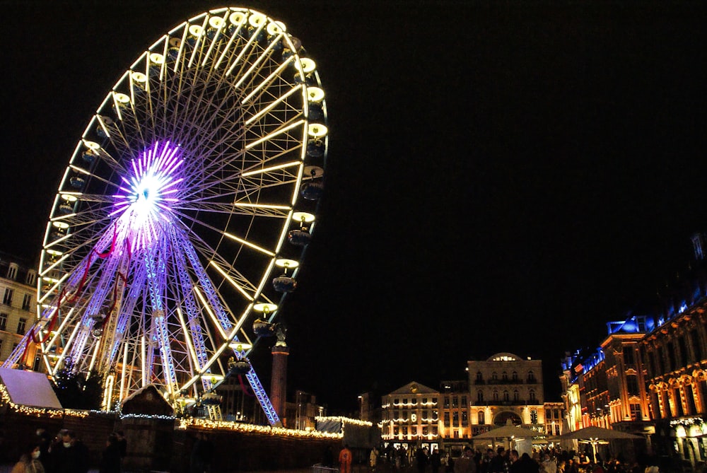 a large ferris wheel lit up at night